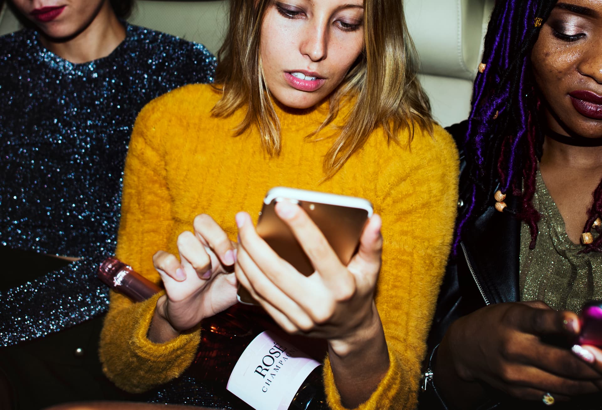 Diverse women in the back seat of a cab